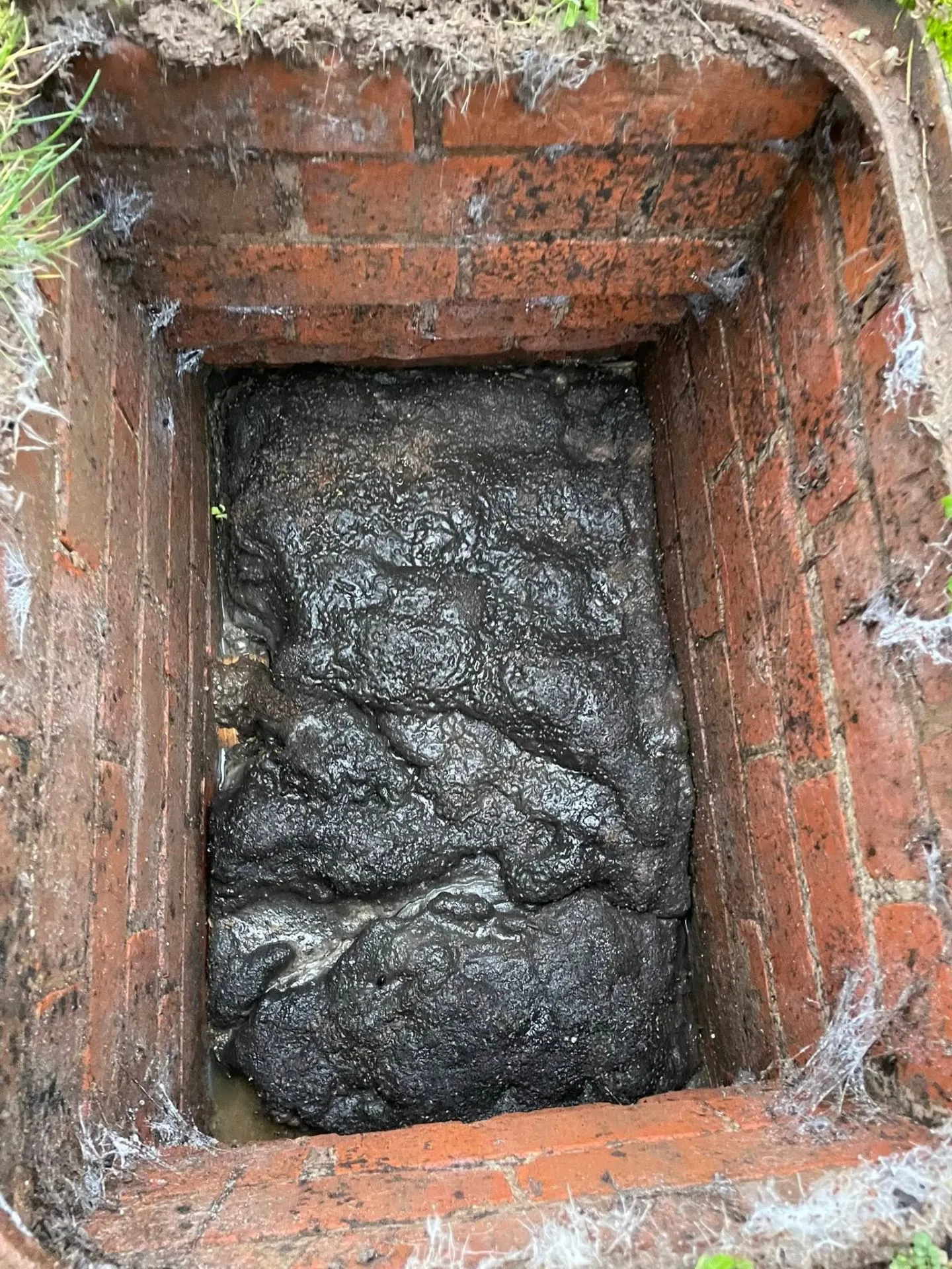 Blocked manhole → clean chamber — before